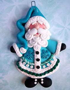 a blue and white santa clause ornament hanging on a wall