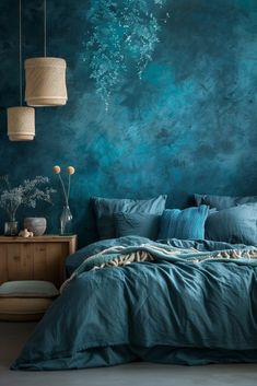 a bedroom with teal walls and blue bedding