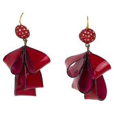 Cilea Paris designed these adorable dimensional dangling pierced earrings. The hand-made artisanal resin earrings feature dimensional ribbons with textured patterns built together to form a powerful statement piece. The pieces boast nice vivid ruby red and silver colors. One earring is marked on the underside with the Cilea - Paris logo. These earrings are for pierced ears. Measurements: 1.57 in wide (4 cm) x 2.94 in high (7.5 cm). Pearl Dangle Earrings, One Earring, Red And Silver, Paris Design, Antique Earrings, Resin Earrings, Modern Earrings, Pierced Earrings, Red Ribbon