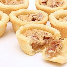 several small pastries sitting on top of a white table