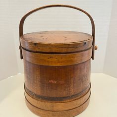 an old wooden bucket sitting on top of a table