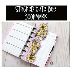 a bookmark with the words, stacked cute bee bookmark on it and an open notebook