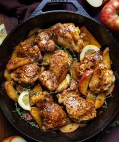 chicken with apples and lemons in a skillet