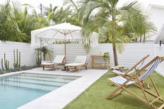 a pool with lawn chairs and an umbrella next to it