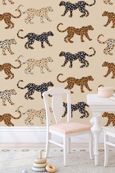 an animal wallpaper with leopards on it and a chair in the foreground