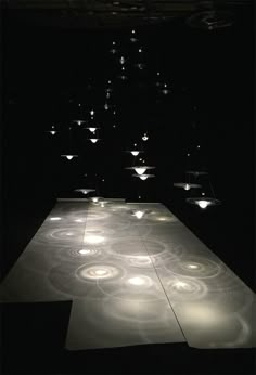 an illuminated dance floor in the middle of a dark room with several lights on it