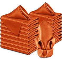 a stack of orange satin napkins sitting on top of each other