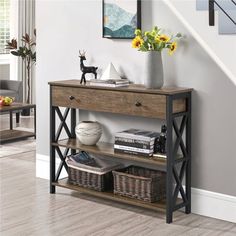 a wooden table with baskets under it next to a stair case in a living room