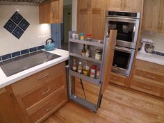 a kitchen with wooden cabinets and stainless steel appliances