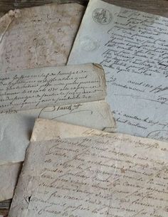 several old letters are laying on top of each other