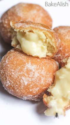 some sugar covered doughnuts on a white plate