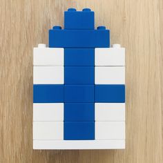 a blue and white lego block sitting on top of a wooden table