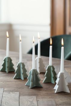 candles are lined up in the shape of christmas trees