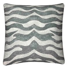 a grey and white pillow with waves on it