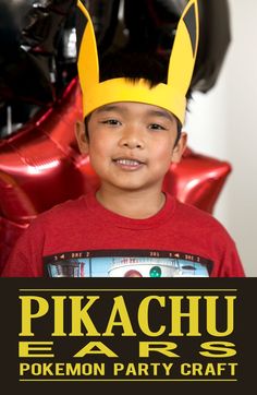 a young boy wearing a pikachu ears t - shirt in front of balloons