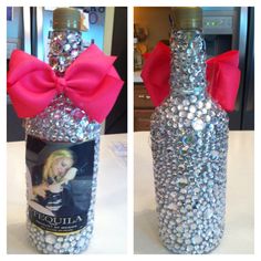 a bottle with a pink bow on the top and an image of a woman's face in it