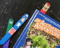 two children's toothbrushes sitting next to an adventure book