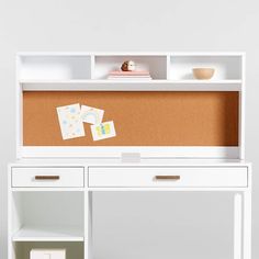 a white desk with a corkboard on the top and two cards placed on it