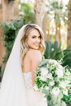 a woman in a wedding dress holding a bouquet