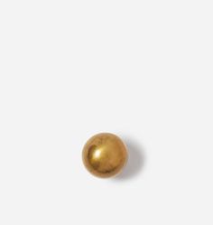 a golden ball on a white surface