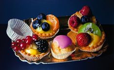 some fruit tarts are sitting on a tray