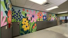 an empty hallway with painted flowers on the wall