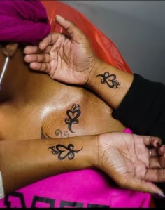 a woman with two tattoos on her chest and one has a pink turban