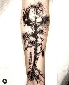 a person with a tattoo on their arm that has an image of a tree in it