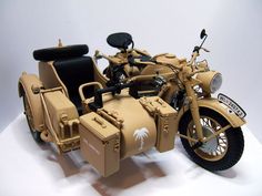 a toy motorcycle with a side car is shown on a white surface and it appears to be made out of cardboard