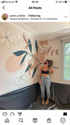 a woman is painting a wall with flowers on it and the words all posts above her