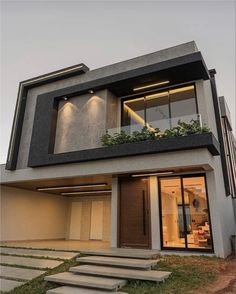 a modern house with stairs leading up to it