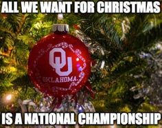 a red ornament hanging from a christmas tree with the words, all we want for christmas is a national championship