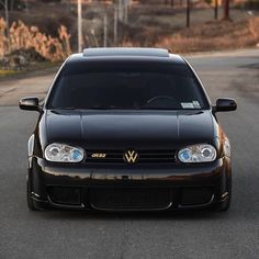 a black car parked on the side of a road