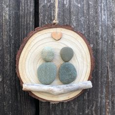 three stones sitting on top of a piece of wood