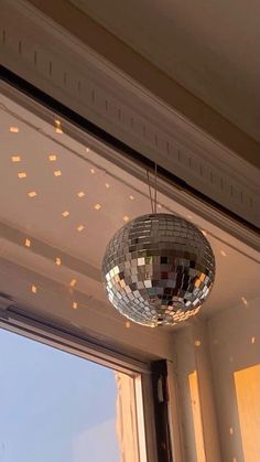 a disco ball hanging from the side of a window