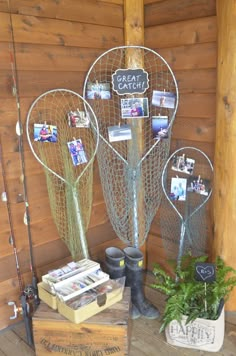 there are many fishing gear on display in the room with wood paneled walls and wooden flooring