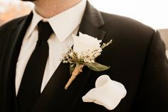 a man in a tuxedo with a boutonniere on his lapel