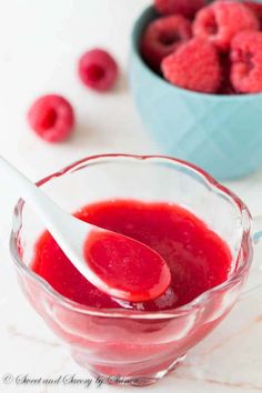 raspberry sauce in a glass bowl with a spoon