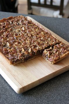 two pieces of granola sitting on top of a wooden cutting board