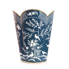 a blue vase with white flowers and birds painted on the side, sitting in front of a white background