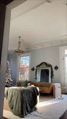 a living room filled with furniture and a christmas tree