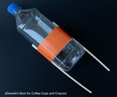 an orange and white toothpick sitting on top of a plastic bottle