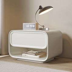 a nightstand with a lamp and books on it in the corner of a living room