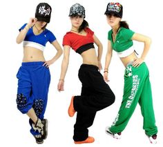 three young women in hip hop style clothing posing for the camera with their hands on their hips