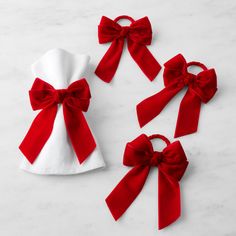 three red and white bows tied on top of each other next to a t - shirt