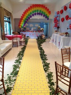 a long yellow brick path with balloons and streamers