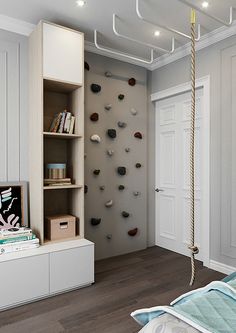 a bedroom with a bed, bookshelf and climbing rope in the corner on the wall