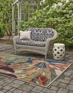 an outdoor area with a couch and rug