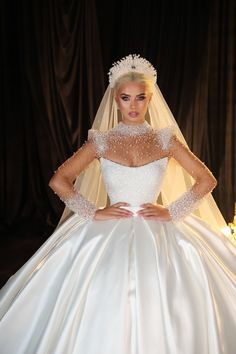 a woman in a wedding dress posing for the camera