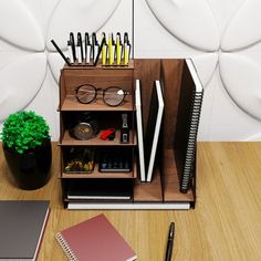 a desk with a notebook, pen and glasses on it